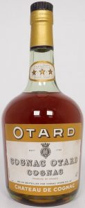 With a castle on the neck label; the neck label has an oval shape; Otard and Chateau de Cognac on brown bands