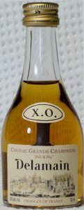 XO and Delamain in black letters. 40% alc/vol on bottom left; 50ml on right; Pale & Dry in smaller letters
