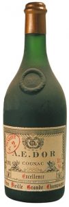 Gold top, glass blob with a crown; year written on the label above 'excellence'. 