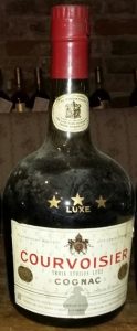 Trois etoiles luxe on the label; standard text underneath; corked cap