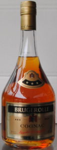Low bottle, clear glass; signature in red