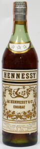 three stars; Schieffelin, New York import (early 1960s); 4/5 quart (stated differently; text also different); different capsule and with embossed text: Federal law forbids sale or reuse of this bottle; longer capsule than previous bottle