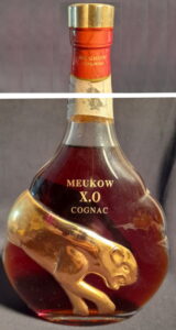 70cl, Portuguese import. Probably one of the first in this kind of bottle. Capsule is orange with Meukow cognac printed horizontally; sadly there was no one picture of the whole bottle (1990s)