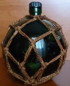Said to be 90cl; green stopper, ecru rope