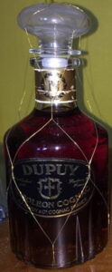 Napoleon fine champagne cognac, N in gold on red on a gold neck band; the emblem on the main label is all black