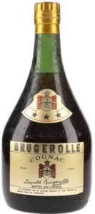 Low bottle, green glass, no content or abv stated, 70cl; shoulder emblem with red colour.