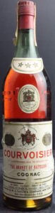 Diferent text under the name 'Courvoisier'; 'all Courvoisier Cognac bears the registred phrase: The Brandy of Napoléon' printed in red. 4/5 Quart; with the General Law sentence (before 1964)