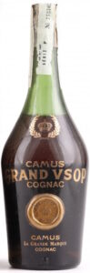 Text on glass in different order: first Camus, then GRAND VSOP, then cognac